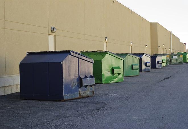 construction debris is tossed into a dumpster on site in Castaic